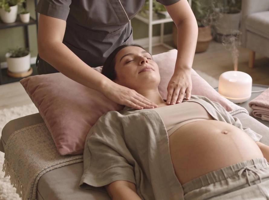 Pregnant woman receiving a soothing mobile pregnancy massage in a comfortable home setting